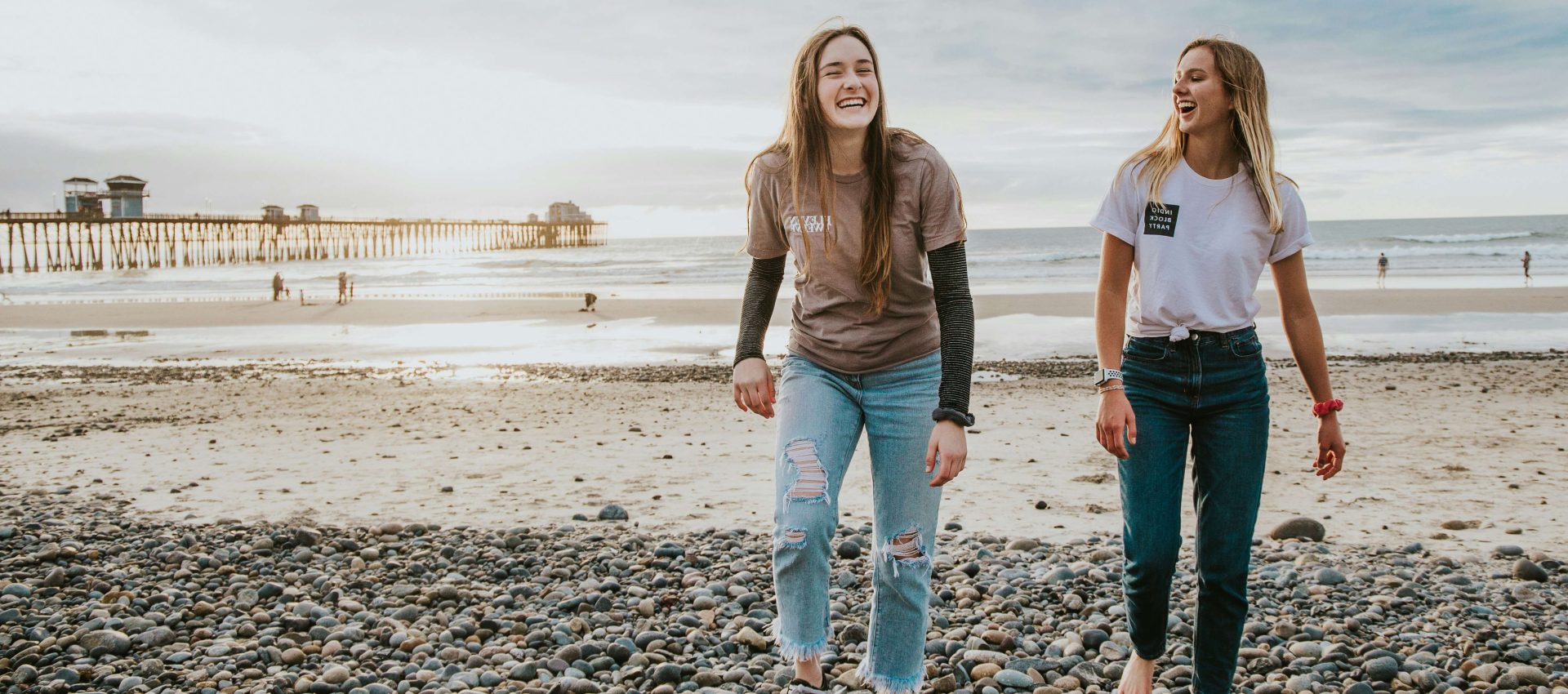 Two friends walking on the beach