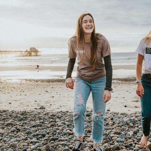 Two friends walking on the beach