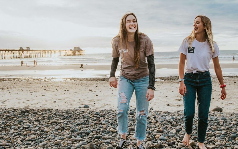 Two friends walking on the beach