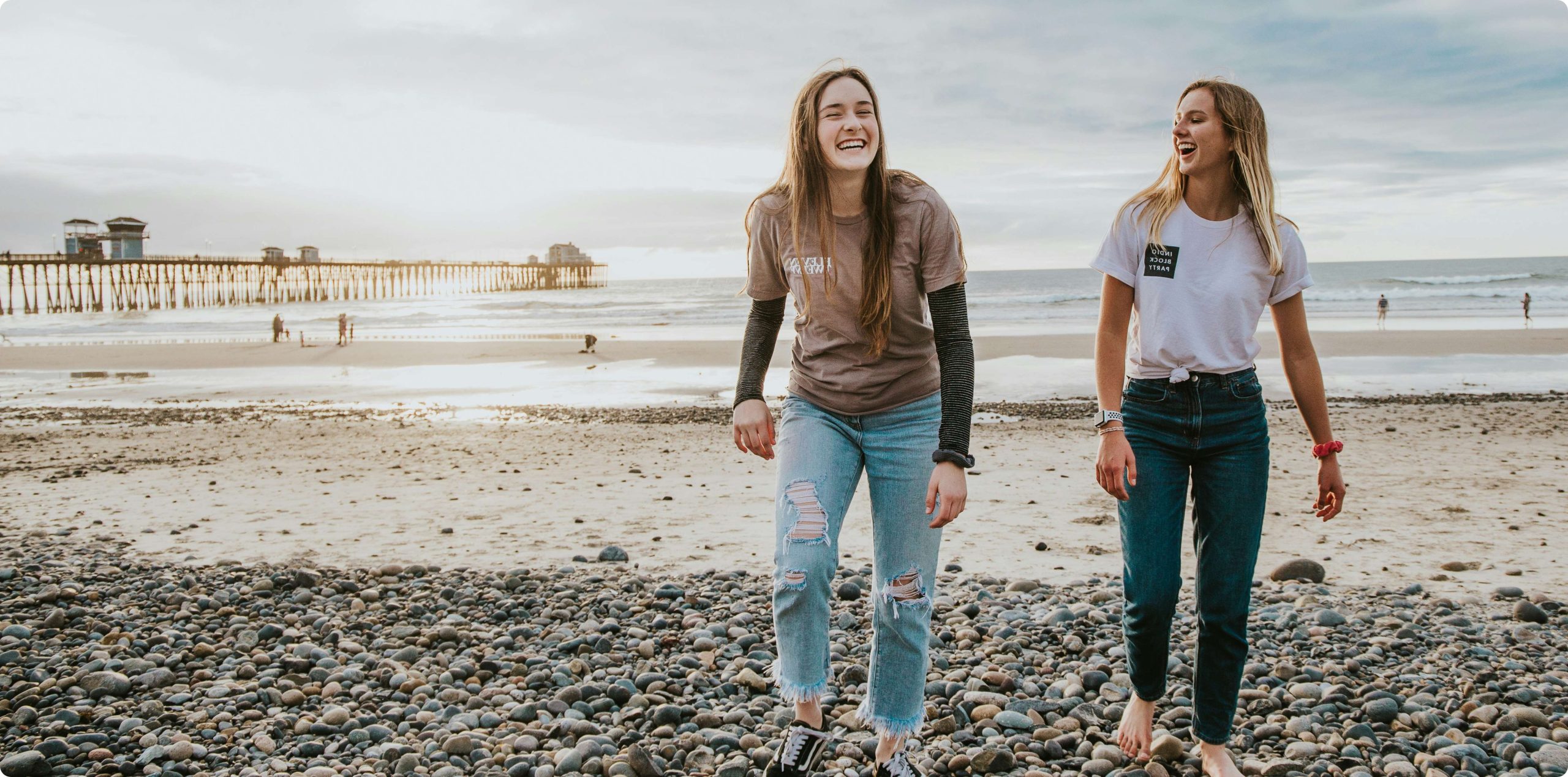 Two friends walking on the beach