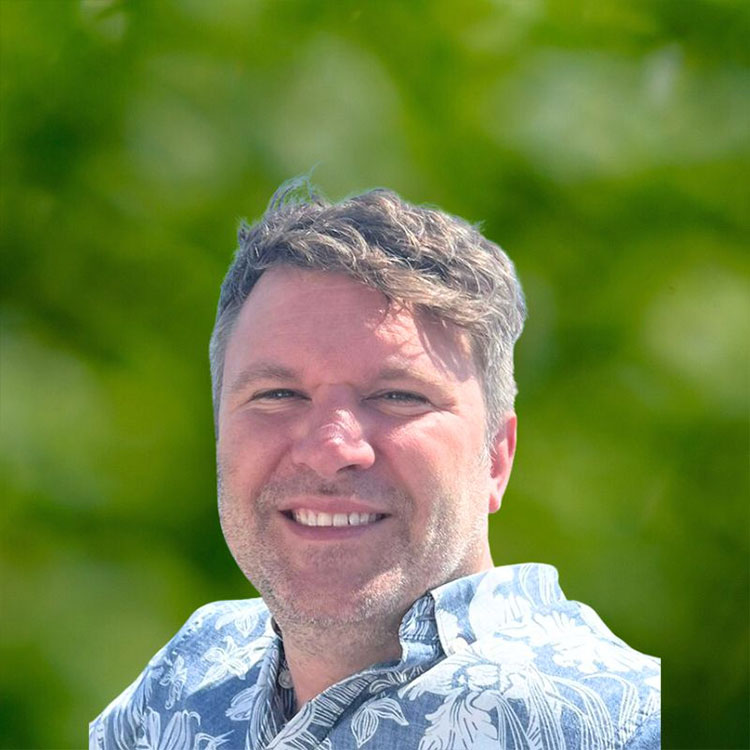 Male smiling while wearing a summer shirt