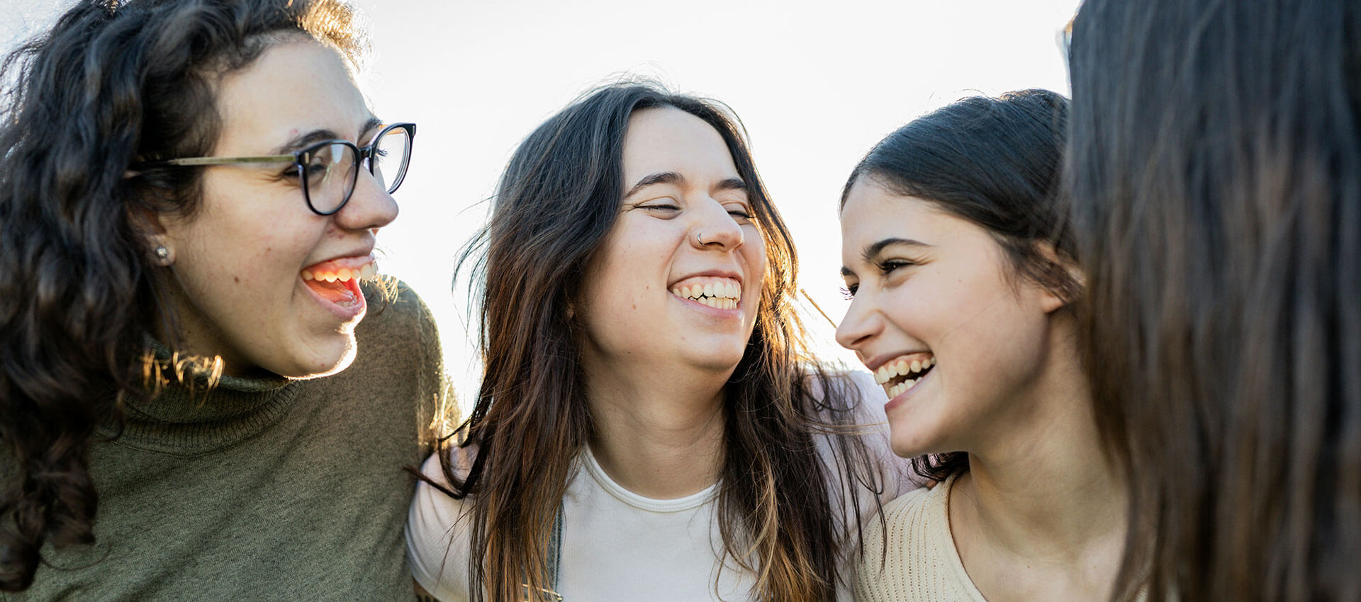 Four people in a group, three are smiling