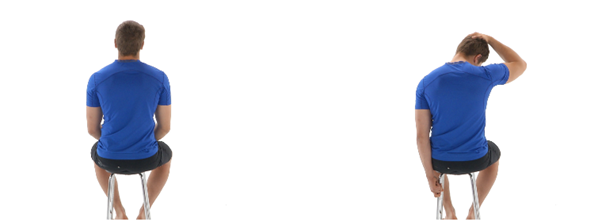 Man in a blue shirt sitting on a stool, initially upright, then tilting his head sideways while grasping his head with one hand in a white studio setting.