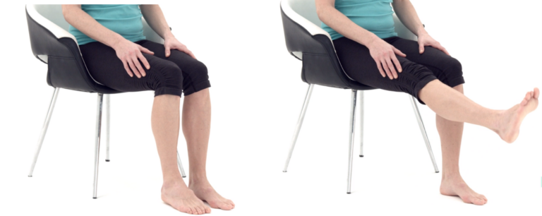 A person in a teal shirt and black pants sits on a chair with metal legs. They extend one leg forward in a stretching motion, set against a plain white background.