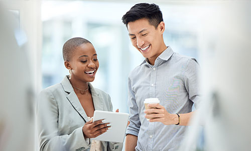 A healthcare professional shows a clipboard to a person in a bright, clinical setting, suggesting a discussion or consultation about health-related information.